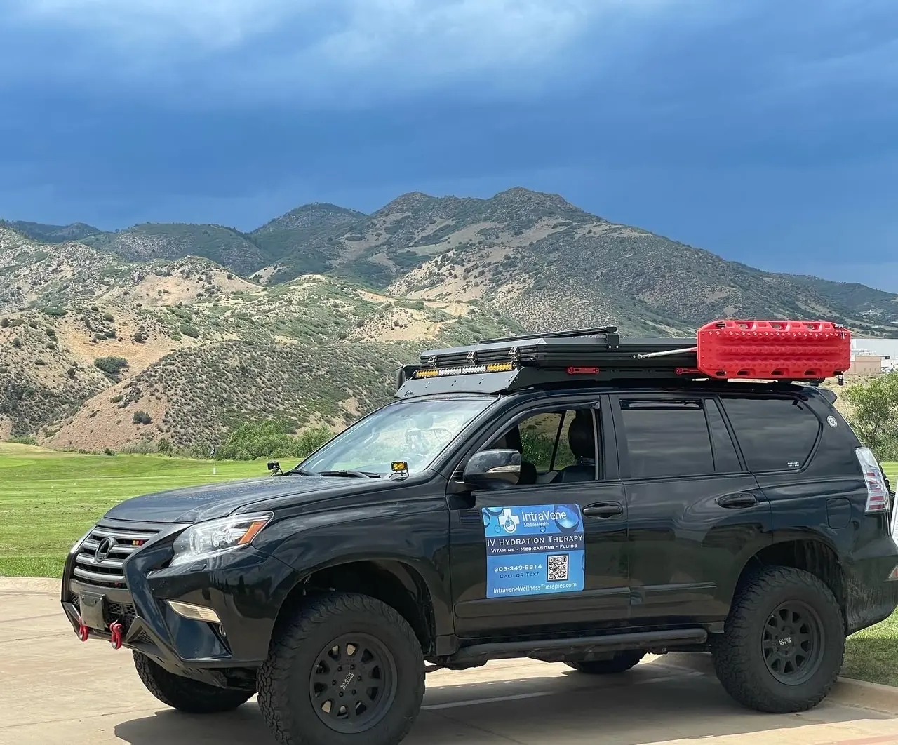 An Intravene mobile IV therapy vehicle parked below the Colorado foothills near Denver