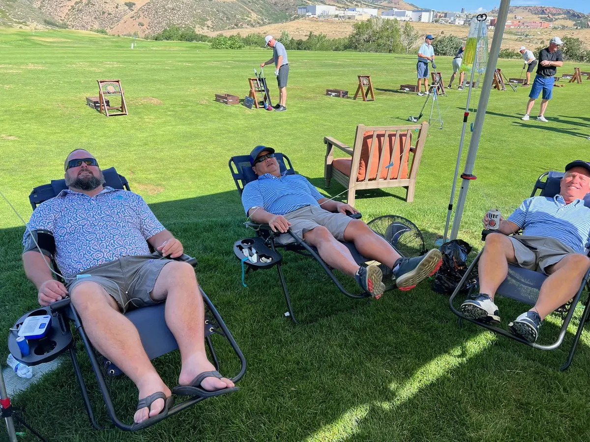 Three people resting in reclining chairs outdoors at altitude in Colorado